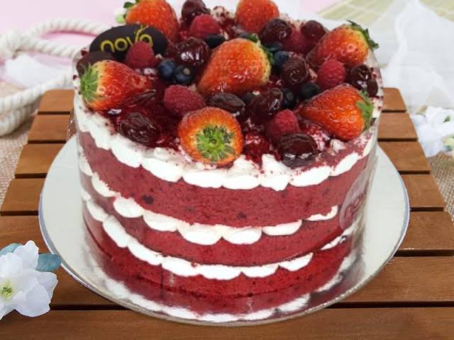 Sliced red velvet cake showing deep red layers and cream cheese frosting