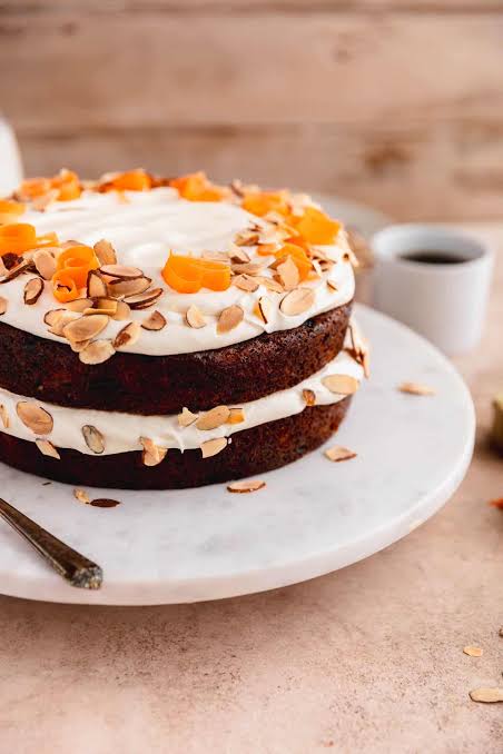 Rustic carrot cake with cream cheese frosting and chopped walnuts